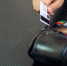 female-hand-with-credit-card-and-bank-terminal-card-machine-or-pos-terminal-with-inserted-blank-white-credit-card-isolated-on-black-background_2.jpg - GorodnaBire.Ru