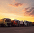 many-transport-trucks-parked-service-station-sunset-ai-generative_1.jpg - GorodnaBire.Ru