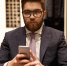 serious-man-suit-eyeglasses-holding-mobile-phone_1.jpg - GorodnaBire.Ru