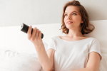 happy-young-lady-sitting-indoors-home-watch-tv_1.jpg